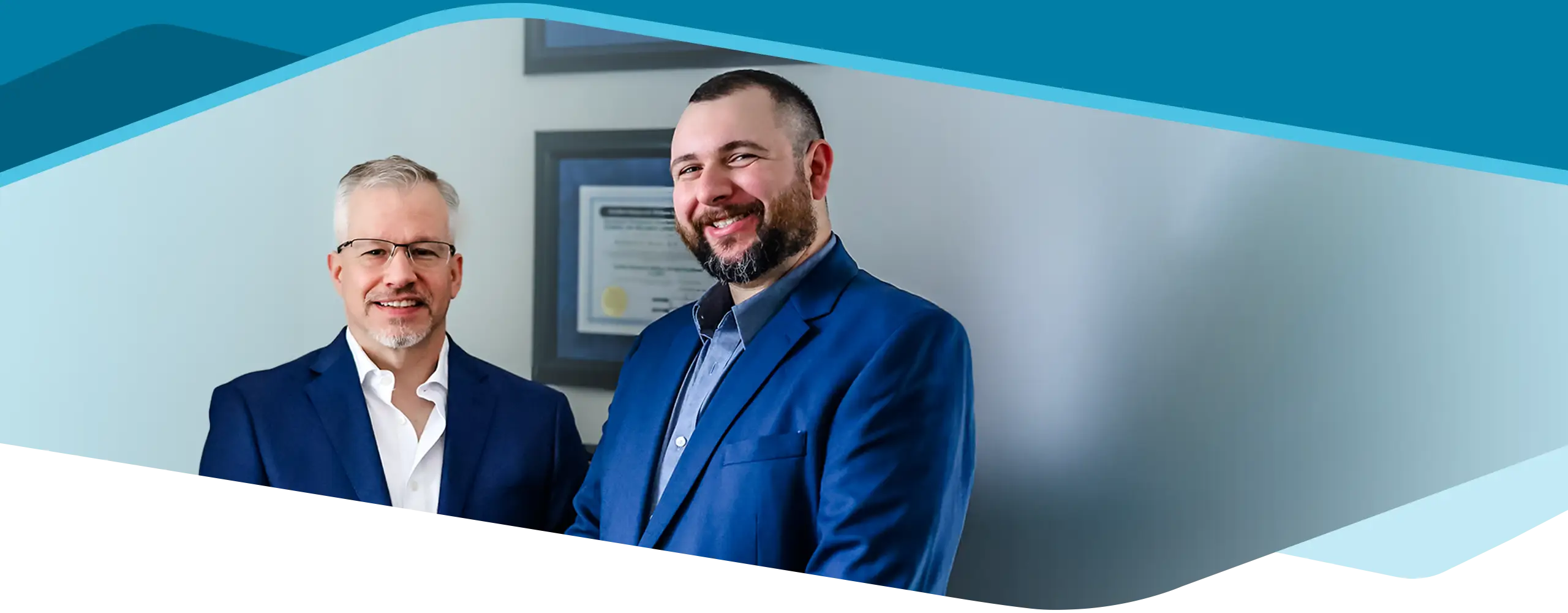 Dr. Richard Hunn and Dr. Mike Roemer smiling in blue suits.